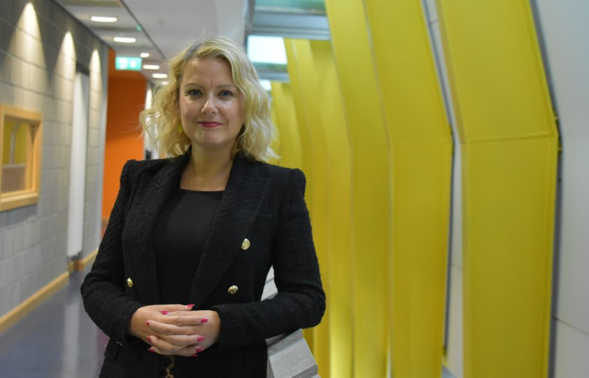 Professor Niamh Stack standing in front of corridor