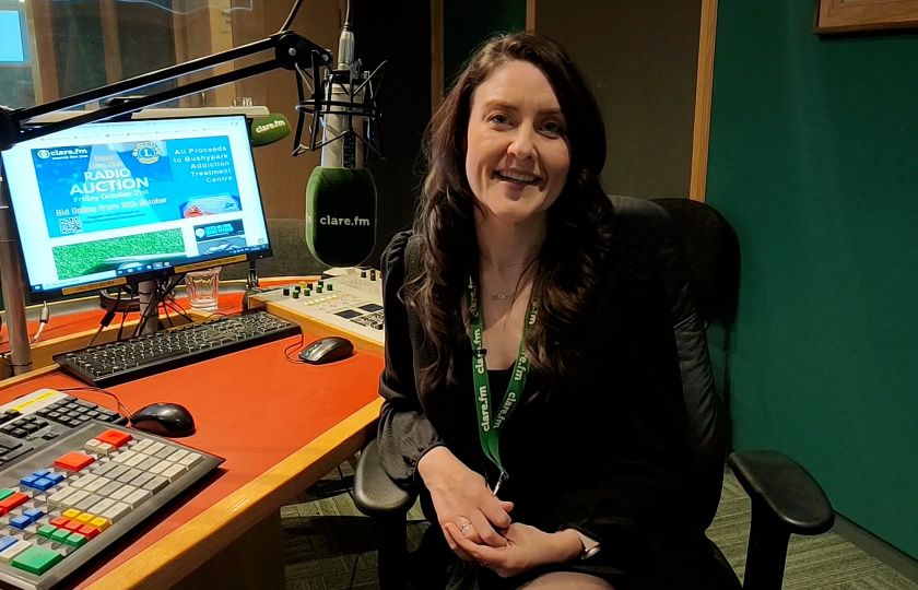 Graduate Fiona Cahill sitting in a radio studio and looking at the camera