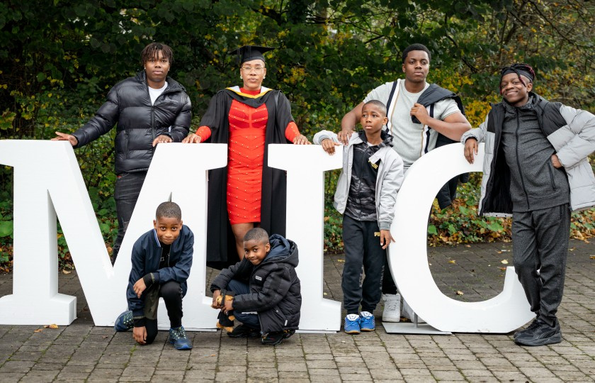 New graduate Joy Bala-Ahmed and here family on the grounds of MIC on graduation day.