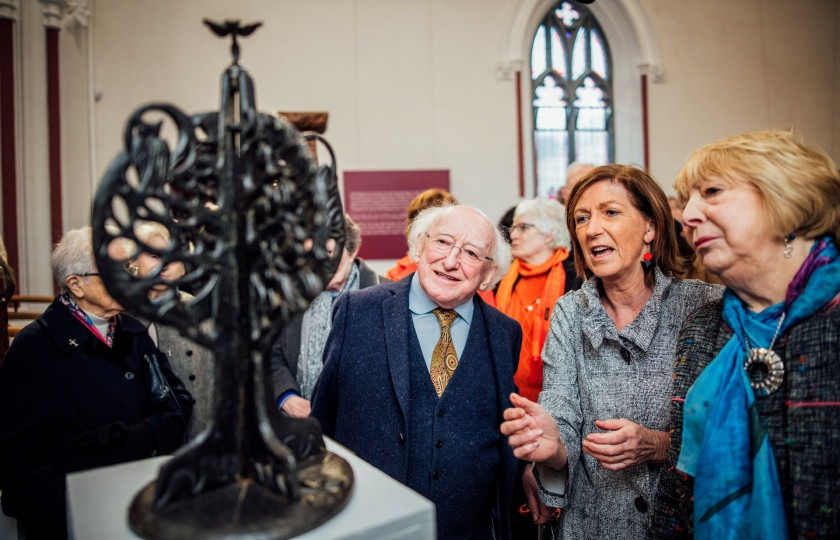 President Higgins and his wife Sabina inspect an exhibition piece with curator Naomi O'Nolan