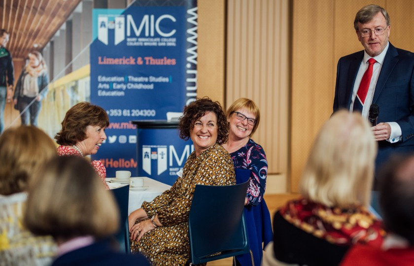 Alumna smiling and laughing.