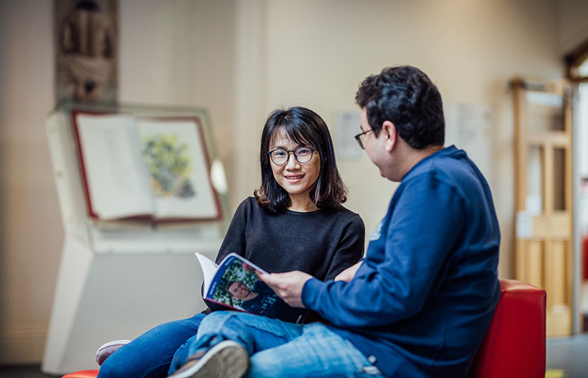 Male and female postgraduate students sitting in the front reception of MIC Limerick campus.