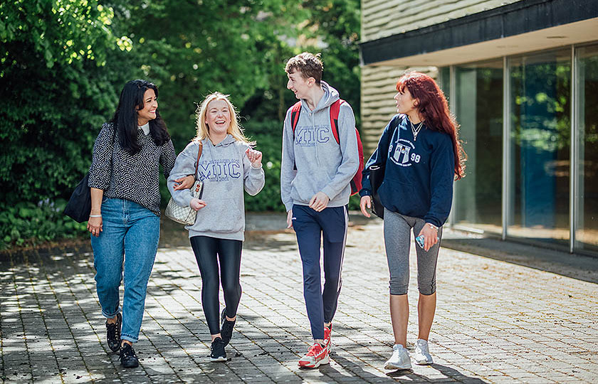 Four students outside sports building at MIC Limerick campus.