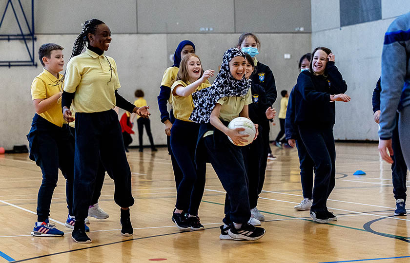 School children at the MIC GAA Centre of Excellence launch, jumping up and reaching for the ball.