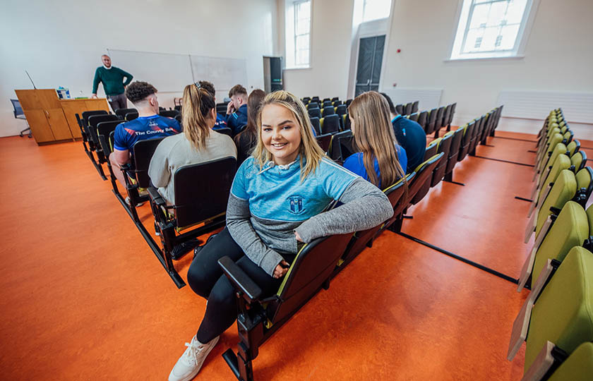 Student looking back at the camera in a classroom.