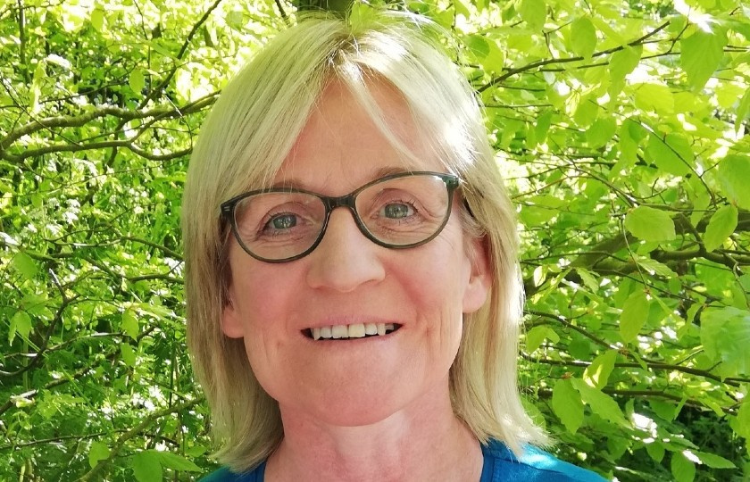 Dr Catherine Stapleton pictured in front of green leaves