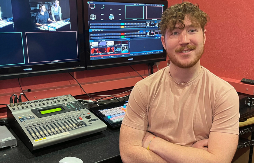 Media Studies student sitting in production studio at MIC.
