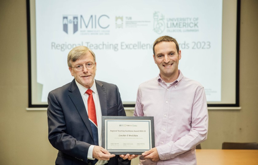 Professor Eugene Wall and Dr Conchúr Ó Brolcháin holding the Regional Teaching Excellence Award