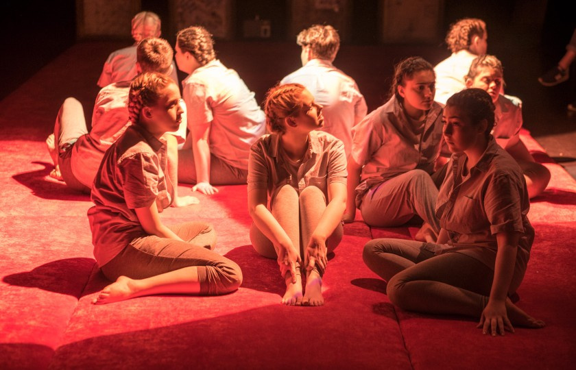 Students sitting on stage during a show