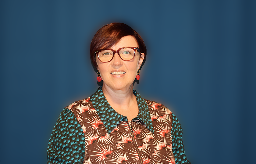 Dr Orla Slattery in front of blue backdrop