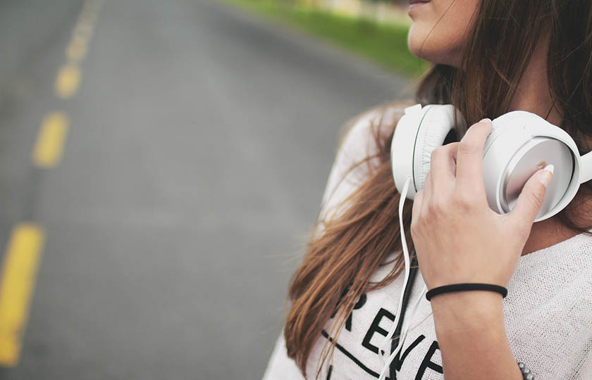 Woman wearing headphones around her neck.