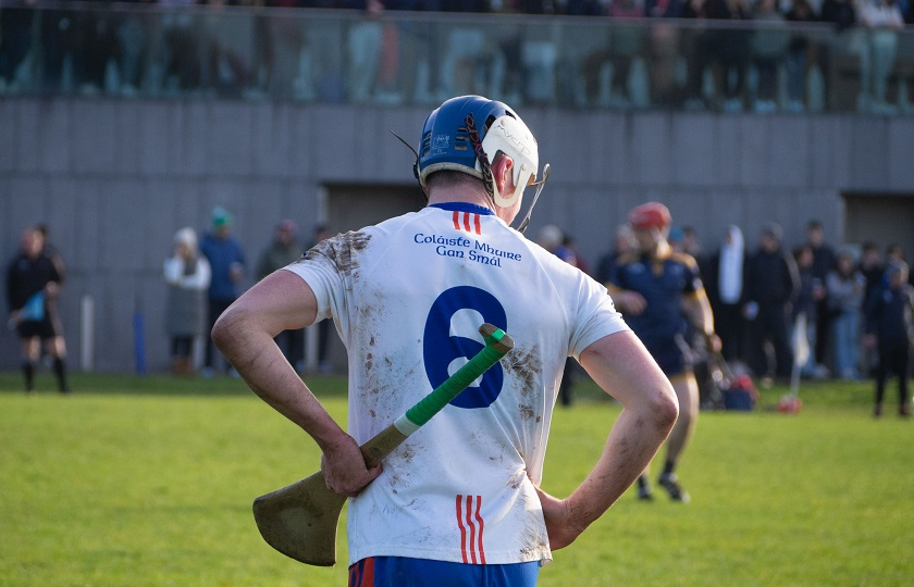 Mary Immaculate College hurler at match with back to camera resting