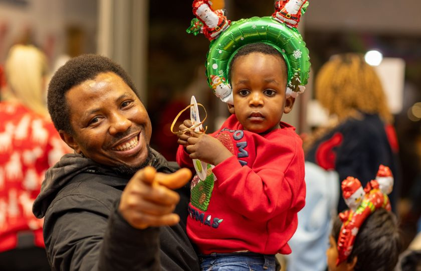 Student Austine Umele pictured with his son at the Christmas party