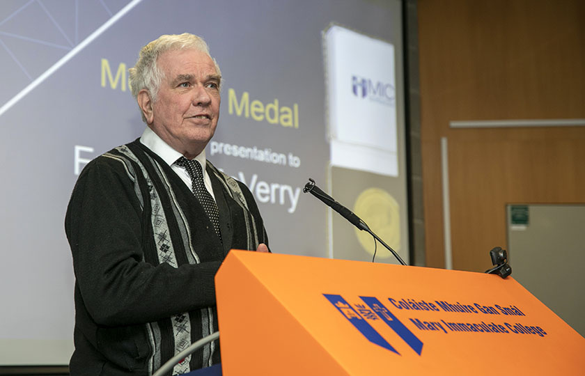 Fr Peter McVerry speaking at a podium as a McAuley Medal recipient in 2022