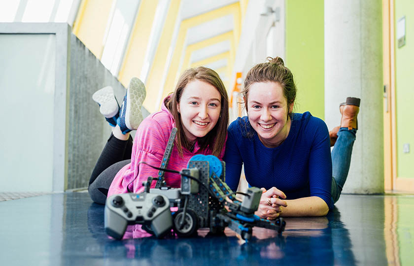 Two girls taking part in a VEX Robotics Training Workshop at Mary Immaculate College 