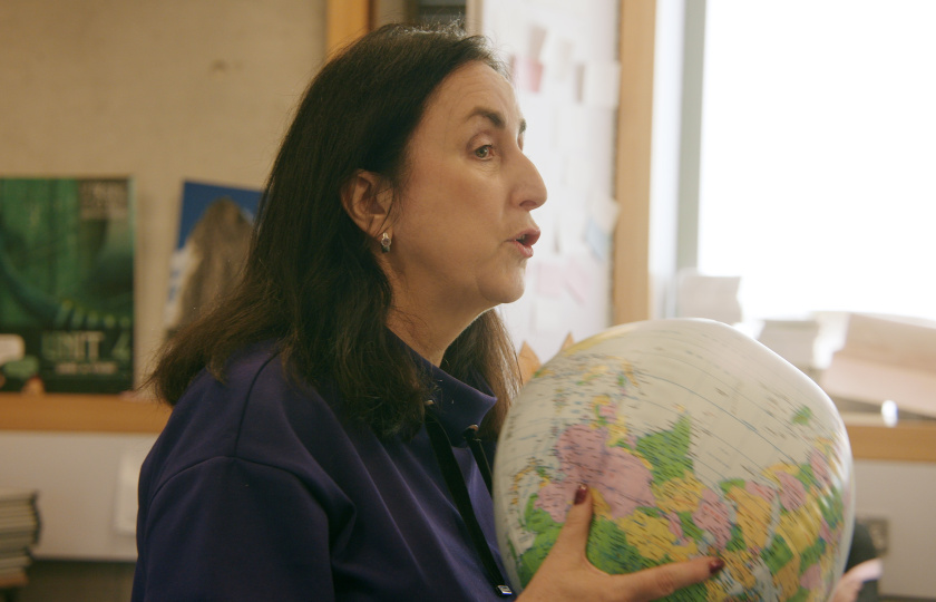 Lecturer holding a globe