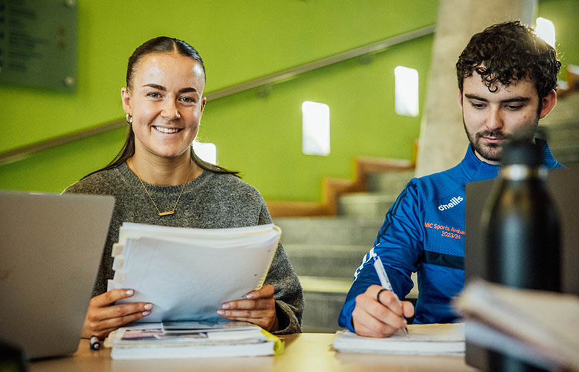 Two students sitting at a desk in TARA building
