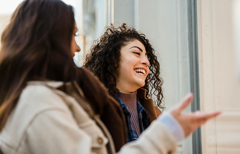 Two women in conversation, laughing