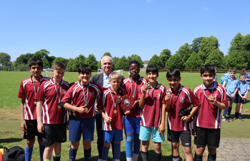 Children's soccer team posing with medals 