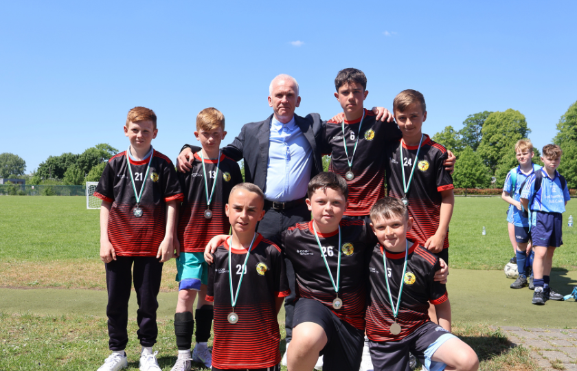 Children's soccer team posing with medals 