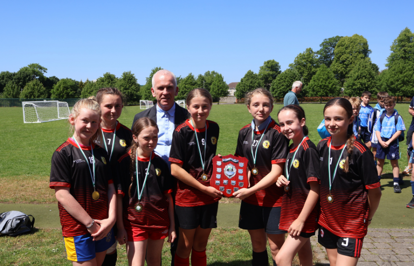Children's soccer team posing with medals 