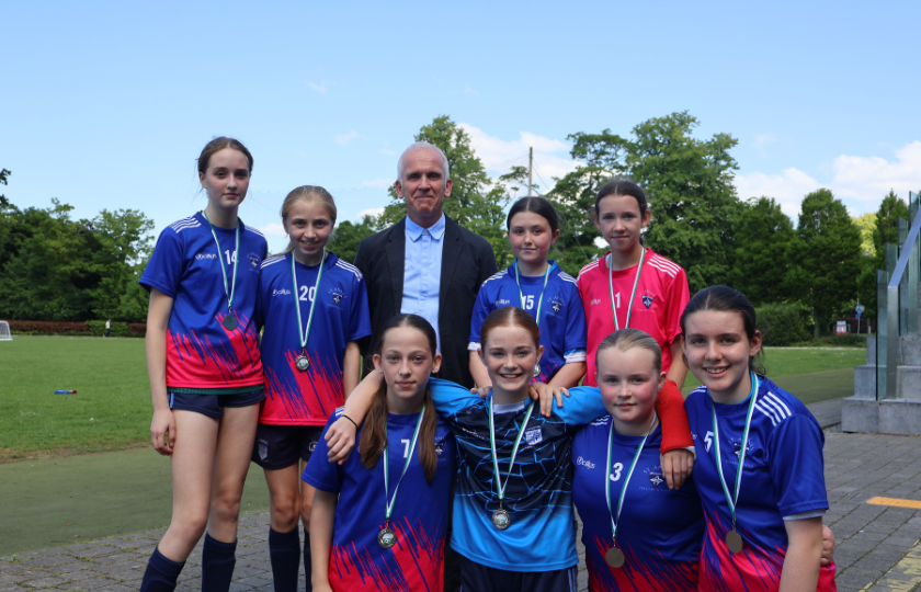 Children's soccer team posing with medals 