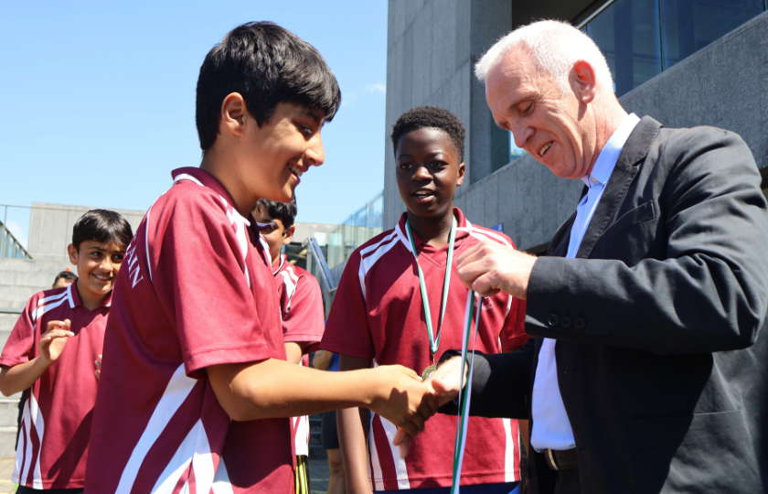 Happy children getting medals for soccer