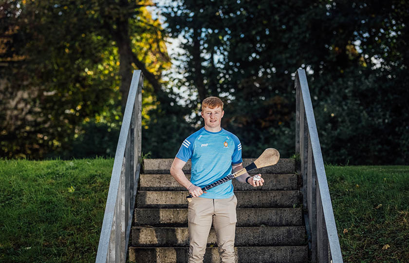 Male recipient of sports scholarship 2024 holding a hurley and sliotar