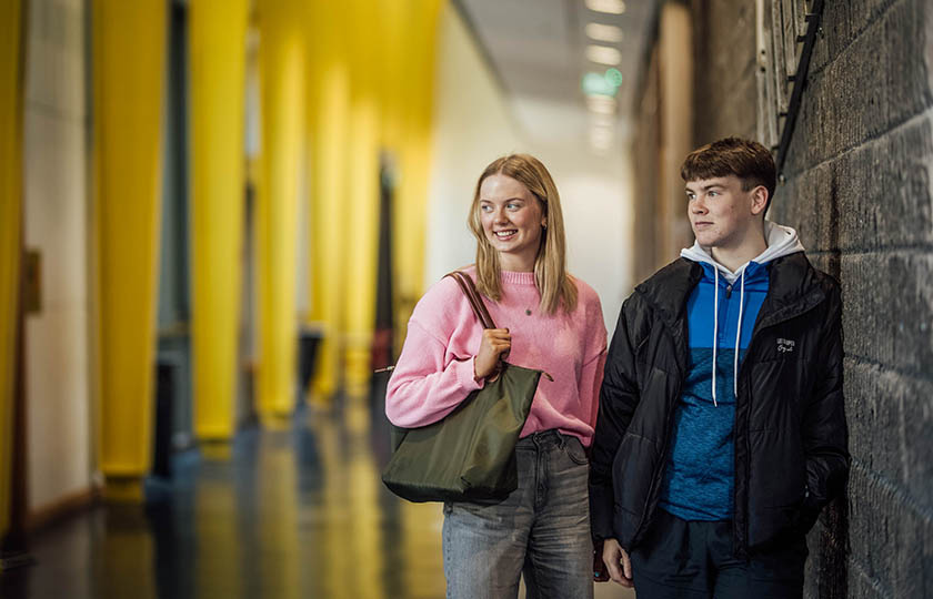 Two students, male and female, in the hallway of the Tara building