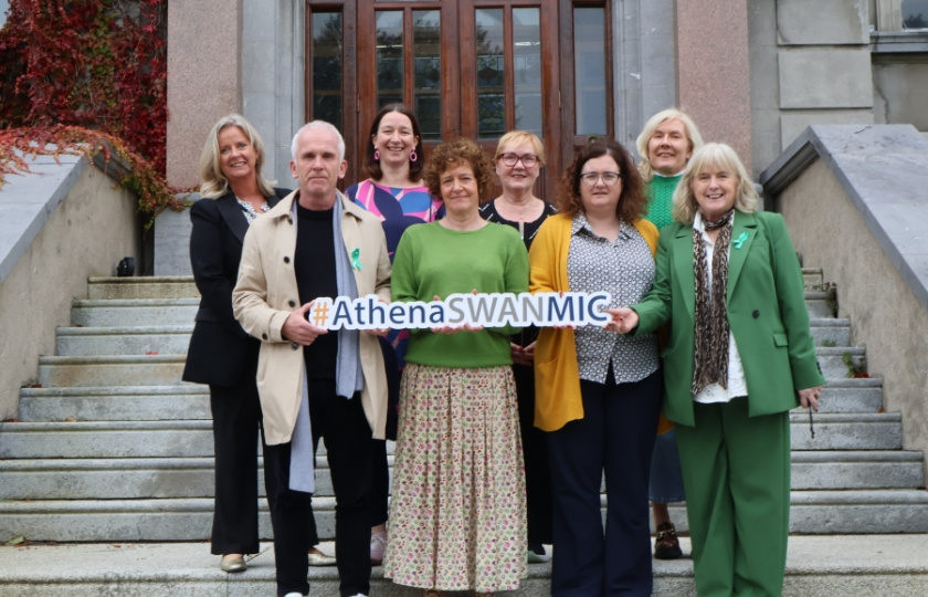 A group of people posing for a photo for an Athena Swan award