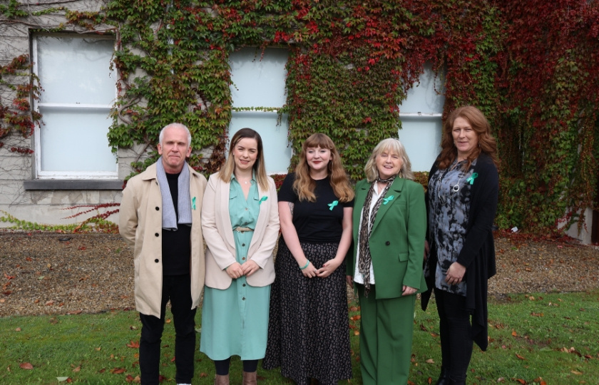 A man and four women posing for a photo for a mental health organisation