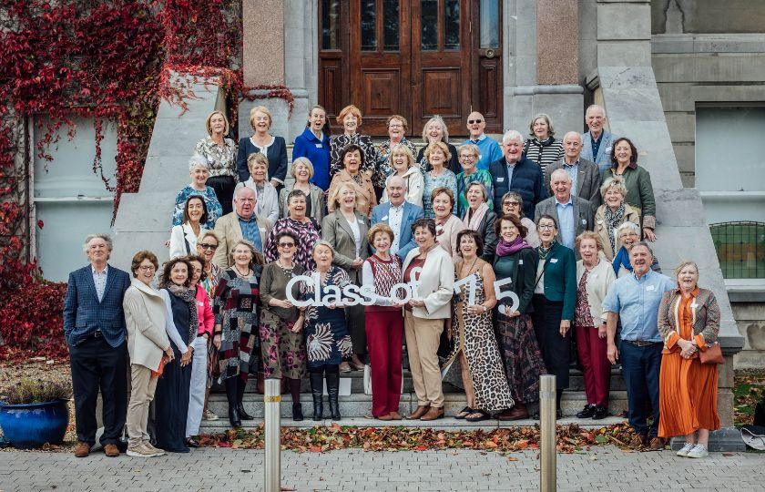 The Class of 75 posing for a photo outside Mary Immaculate College