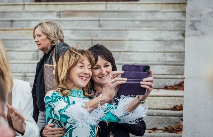 Two women smiling while posing for a selfie