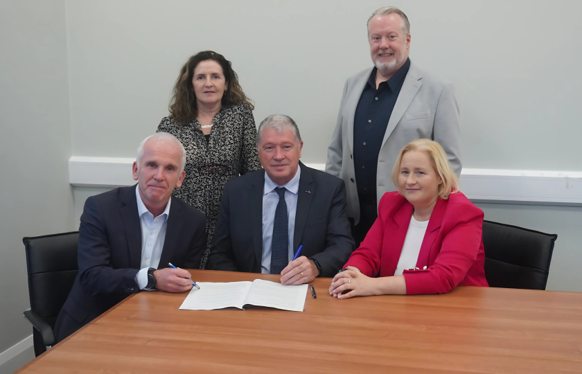 A group of people signing a Memorandum of Understanding between MIC and Kerry ETB