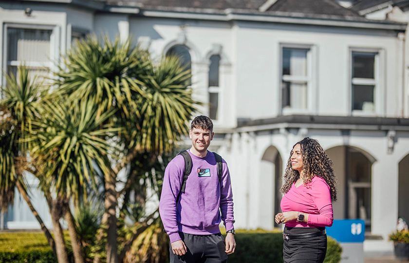 Two students standing outside the Summerville building.
