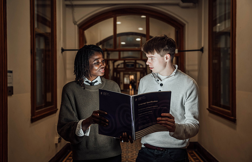 Two students reading together.