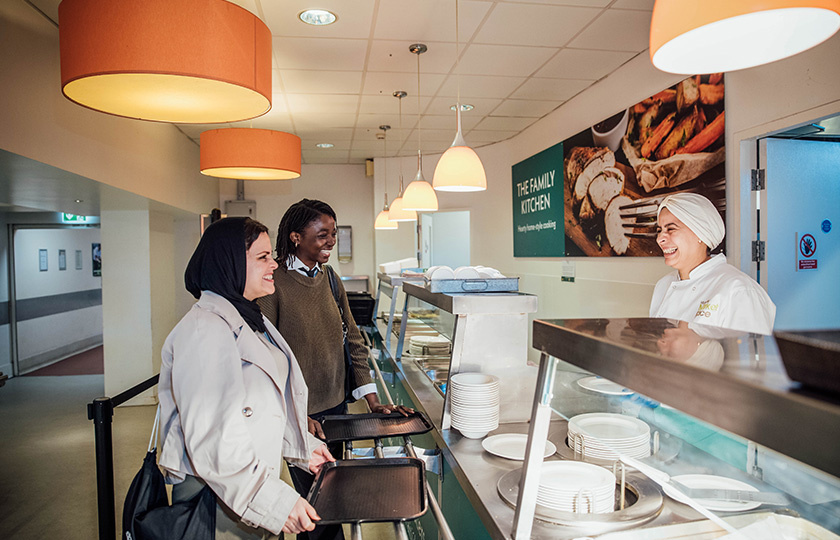 Two students ordering food at the cafeteria.