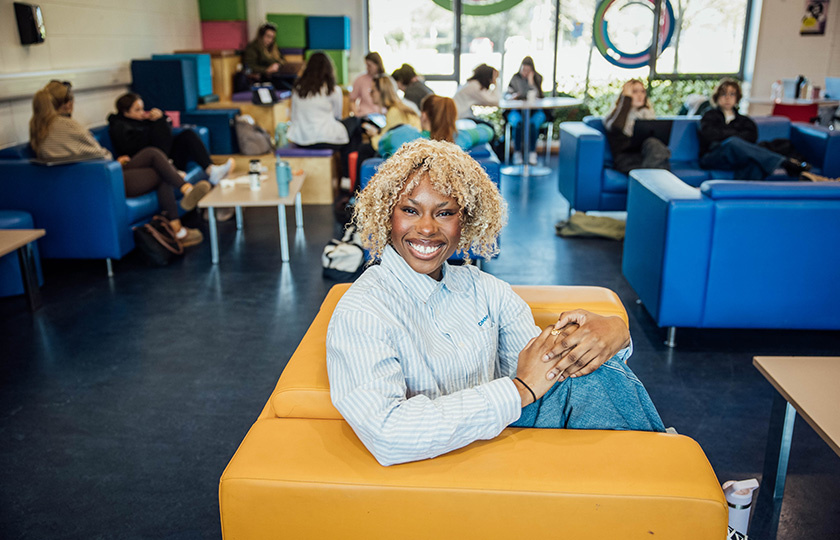 A student sitting in the student union's lounge area.