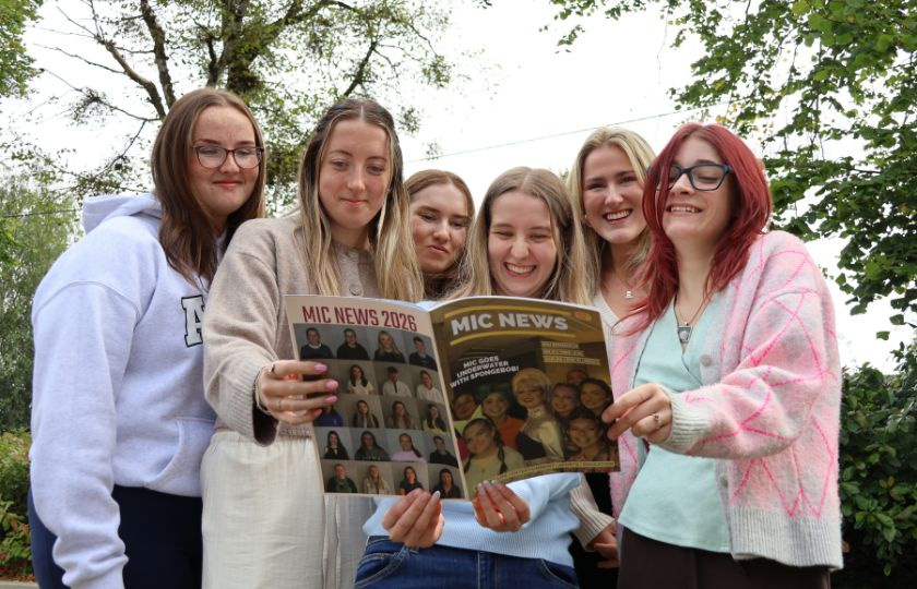 Students with a student newspaper