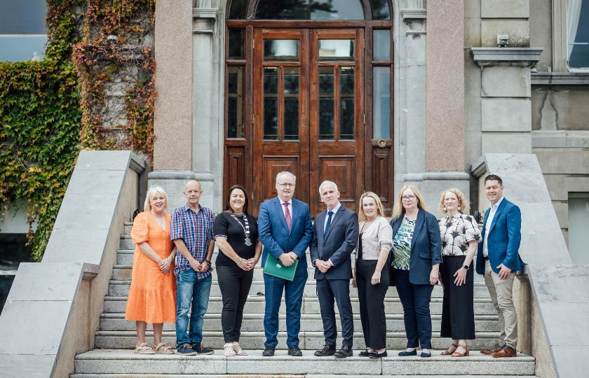 Photo of President and those involved in report and launch outside foundation building in Mary Immaculate College