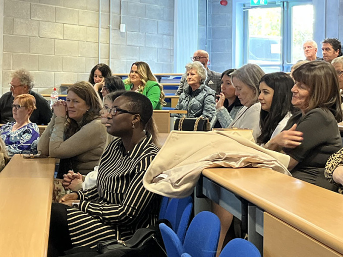 Staff and students sitting in lecture theatre at 20 years celebration of ECCE at MIC
