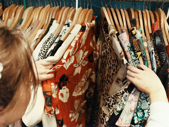Woman looking through clothes on a rail