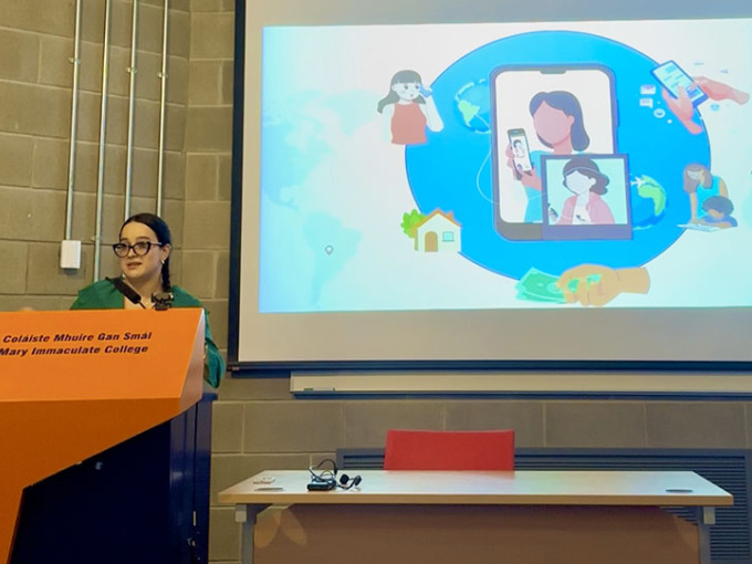 Maria Paola Ayala Godoy - ICTS Visiting Research Scholar giving a talk at a podium in one of the MIC lecture theatres.