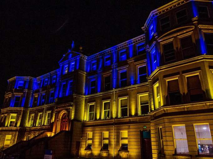 MIC Foundation building lit up in Ukraine colours