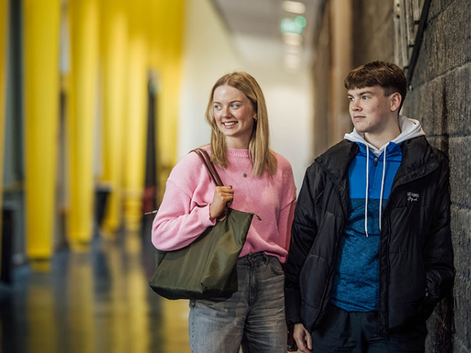 Two undergraduate students in TARA building hallway